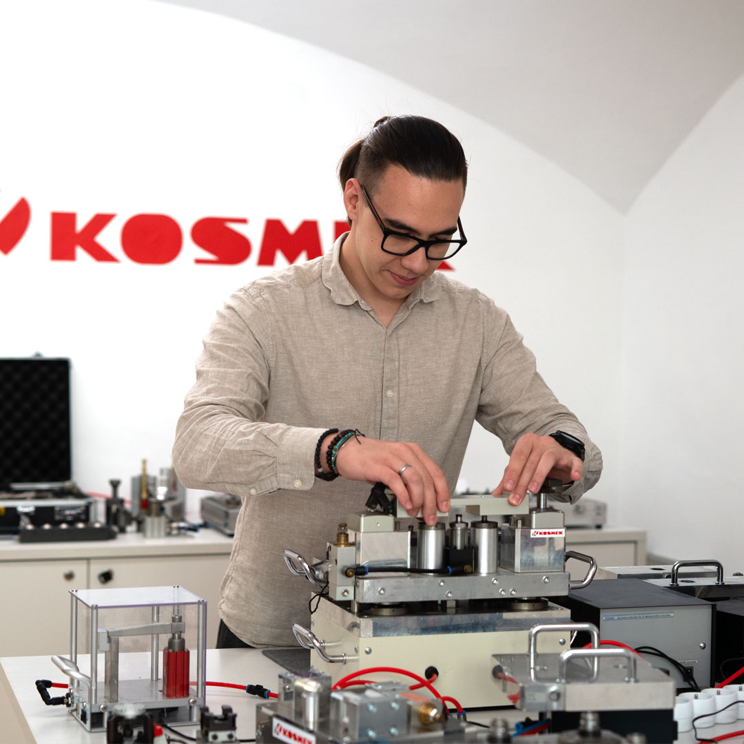 Technician assembling precision clamping system during service support at KOSMEK.