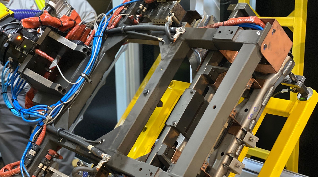 Automated jig-less welding fixture equipped with KOSMEK SWP Expansion Locating Pin Clamps at Nissan UK, improving accessibility and weld precision.