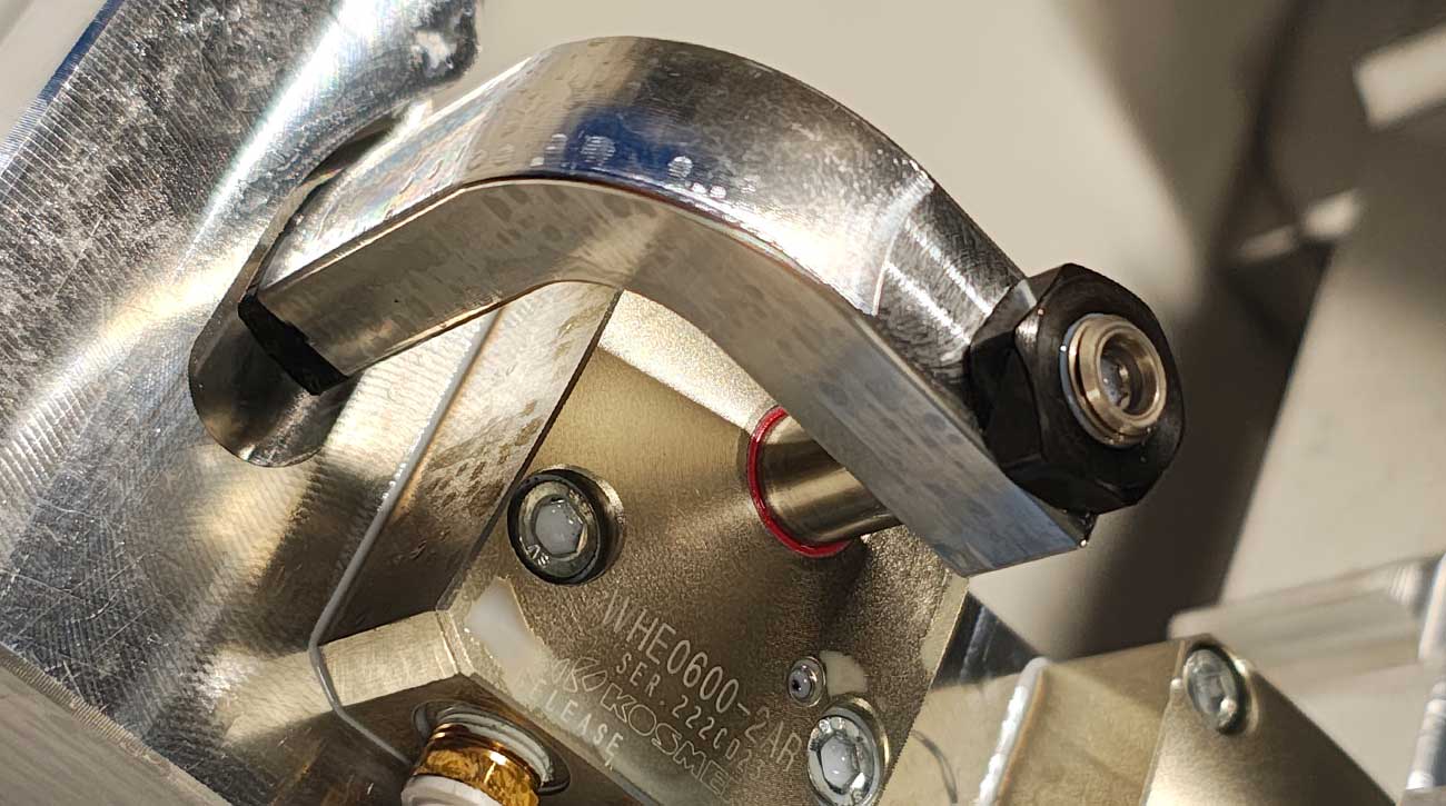 Close-up of KOSMEK WHE oil-free pneumatic swing clamp used at INTERAL for precise and maintenance-free clamping.