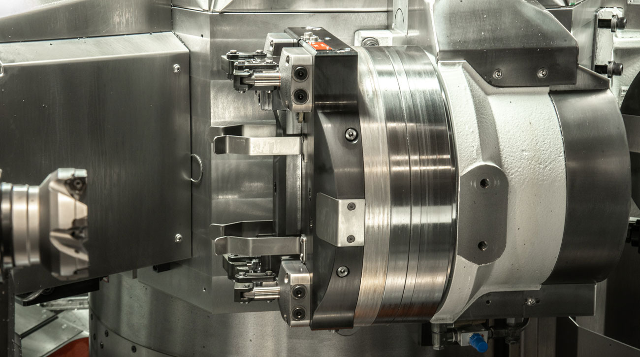Compact KOSMEK clamps hold the workpiece securely during automated machining in the SEMA MT30X machine.