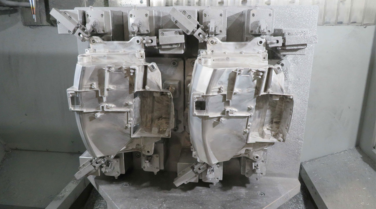 Two magnesium components clamped in the pneumatic fixture at LTC.